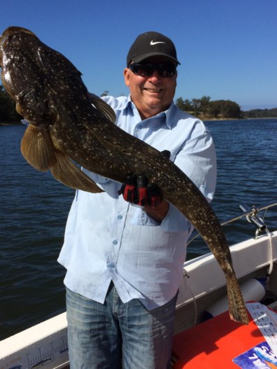 Joe with a 93cm Flathead at Lake Tyers Beach