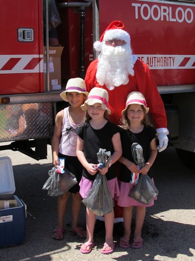 Santa with happy kids at Lake Tyers Beach