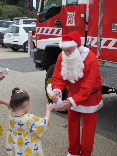 Santa at Lake Tyers Beach with a beautiful helper