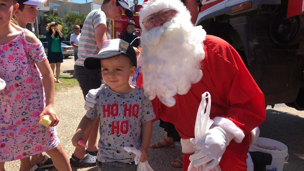 Santa at Lake Tyers Beach with a beautiful helper